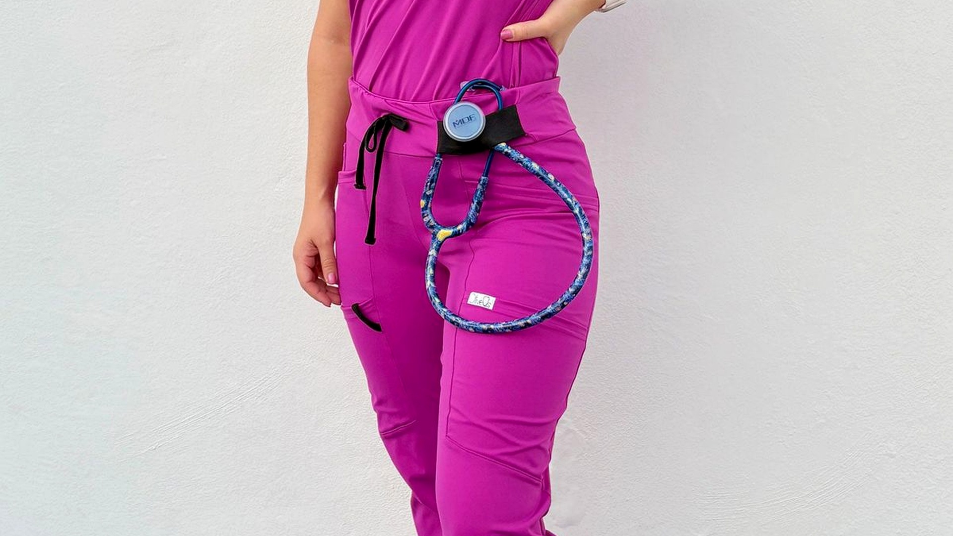 HD nurse in magenta scrubs with stethoscope